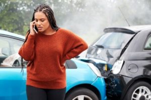 A woman calling her attorney after a car accident in Dallas.