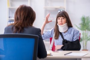 Injured woman talking to her lawyer about her personal injury case in Denton, Texas.